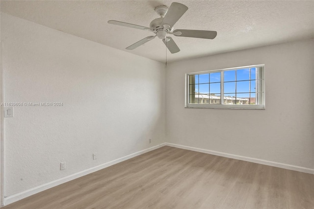 unfurnished room featuring ceiling fan, a textured ceiling, and light wood-type flooring