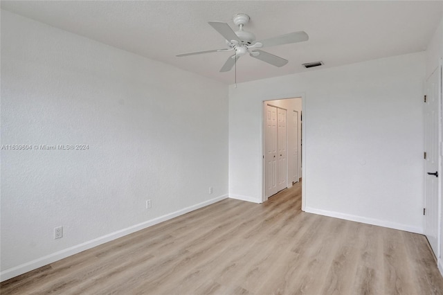 spare room featuring light hardwood / wood-style floors and ceiling fan