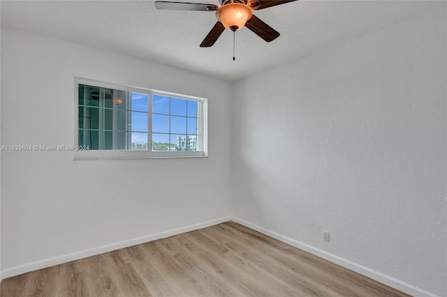 empty room with ceiling fan and light wood-type flooring