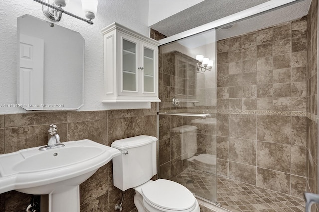 bathroom with an enclosed shower, sink, and toilet