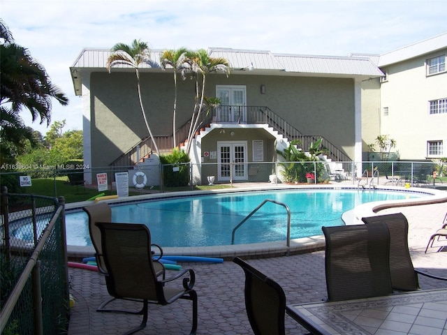 view of pool with french doors