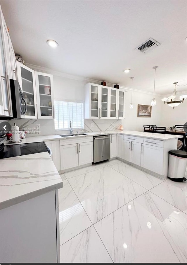 kitchen with sink, decorative light fixtures, stainless steel appliances, and white cabinets