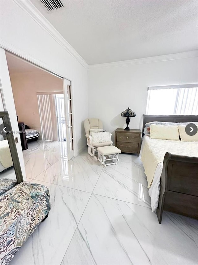 bedroom featuring ornamental molding and a textured ceiling