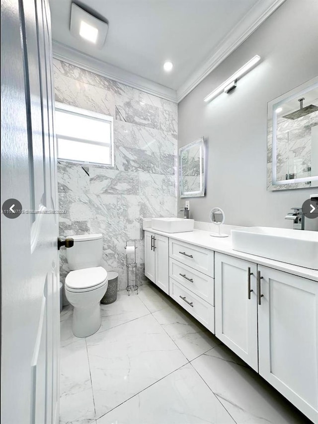 bathroom with tile walls, toilet, vanity, walk in shower, and crown molding