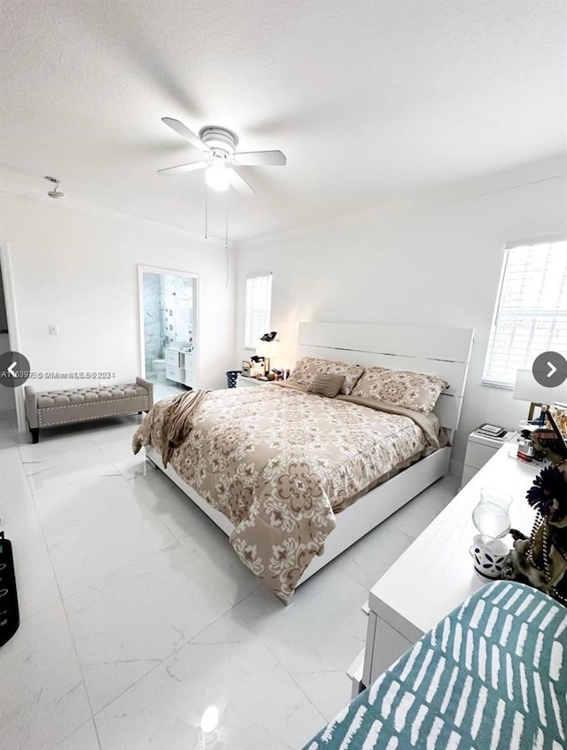 bedroom with ceiling fan and a textured ceiling