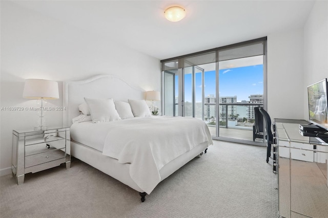 bedroom featuring access to outside, light carpet, and a wall of windows