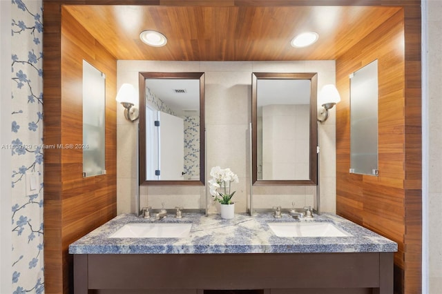 bathroom featuring vanity and wooden walls