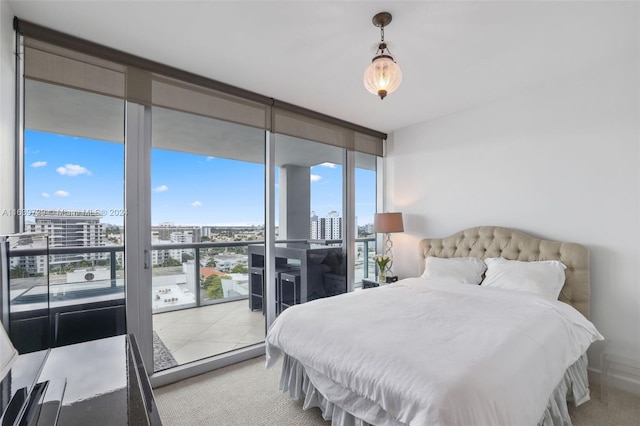 bedroom with floor to ceiling windows, light colored carpet, and multiple windows