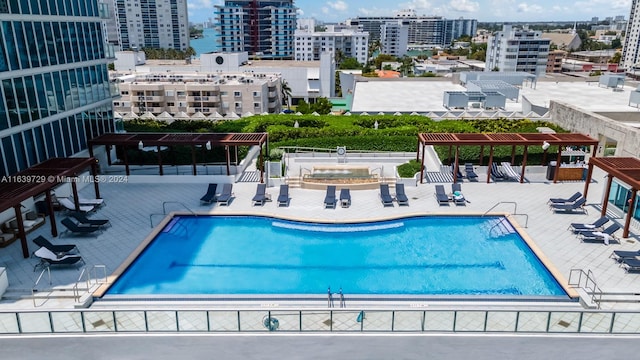 view of swimming pool with a pergola and a patio