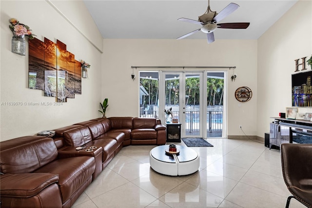 tiled living room featuring french doors and ceiling fan