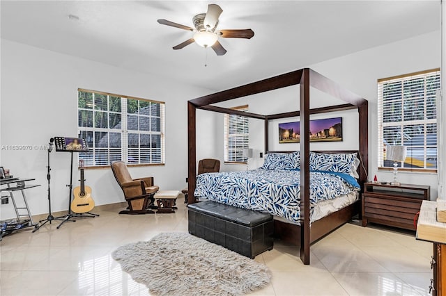 tiled bedroom featuring ceiling fan and multiple windows