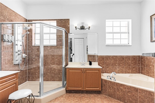 bathroom with plenty of natural light, vanity, and tile patterned flooring