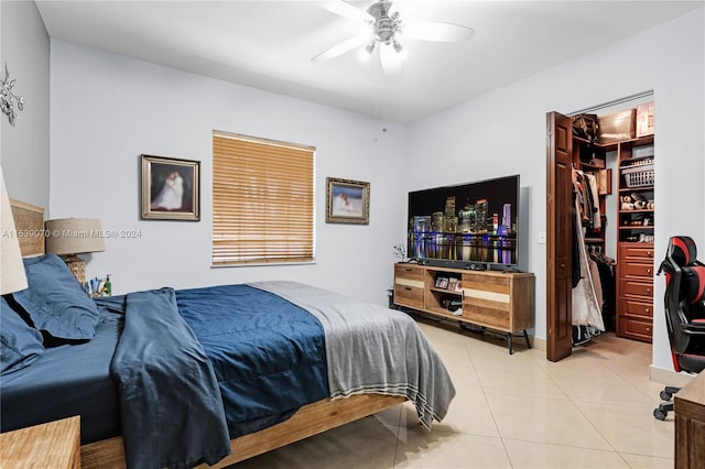 bedroom featuring light tile patterned floors, a closet, and ceiling fan