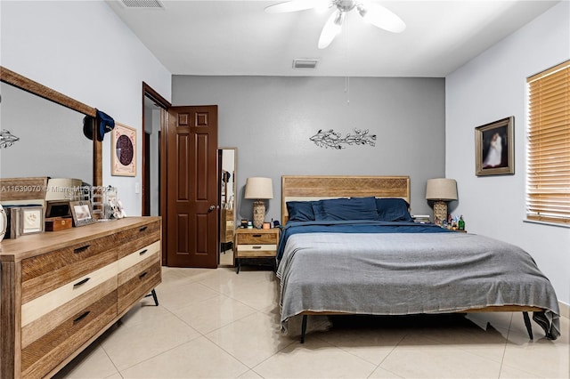 tiled bedroom with ceiling fan