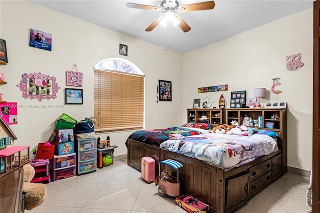 tiled bedroom featuring ceiling fan