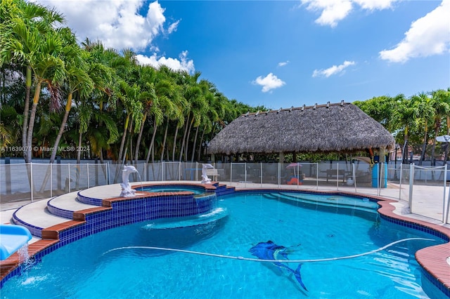 view of swimming pool with an in ground hot tub, pool water feature, and a gazebo