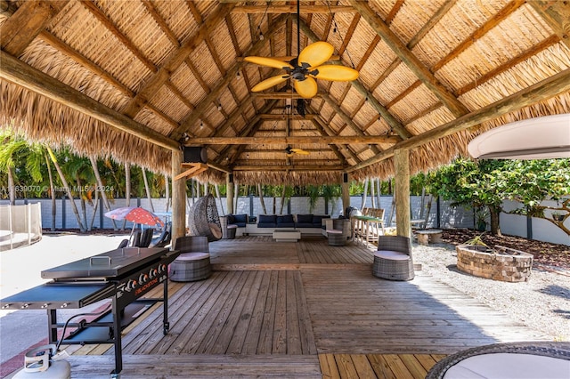 deck with ceiling fan, an outdoor hangout area, and a gazebo