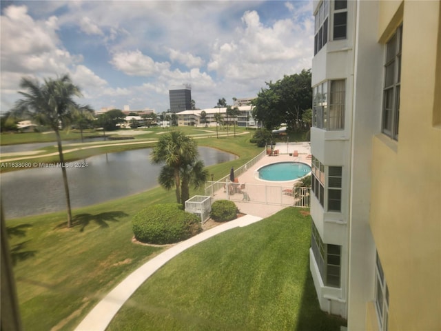 view of yard featuring a water view and a community pool