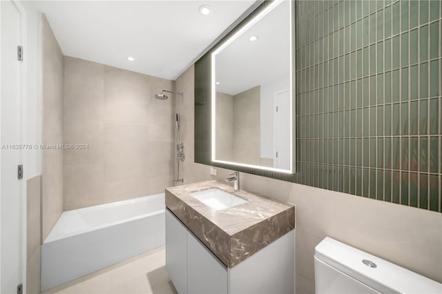 bathroom with toilet, shower / tub combination, vanity, tile walls, and recessed lighting