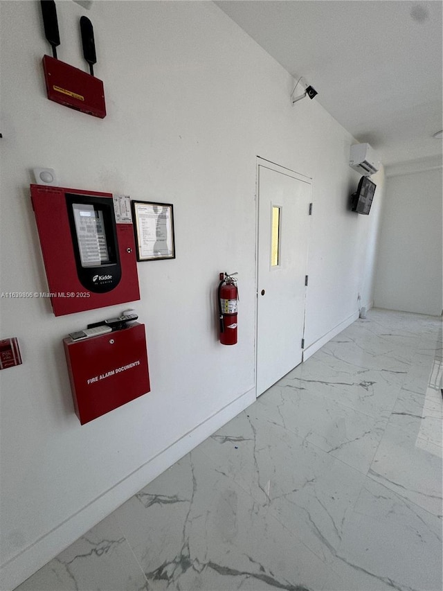 hall featuring a wall unit AC