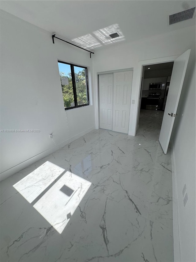 unfurnished bedroom with a closet