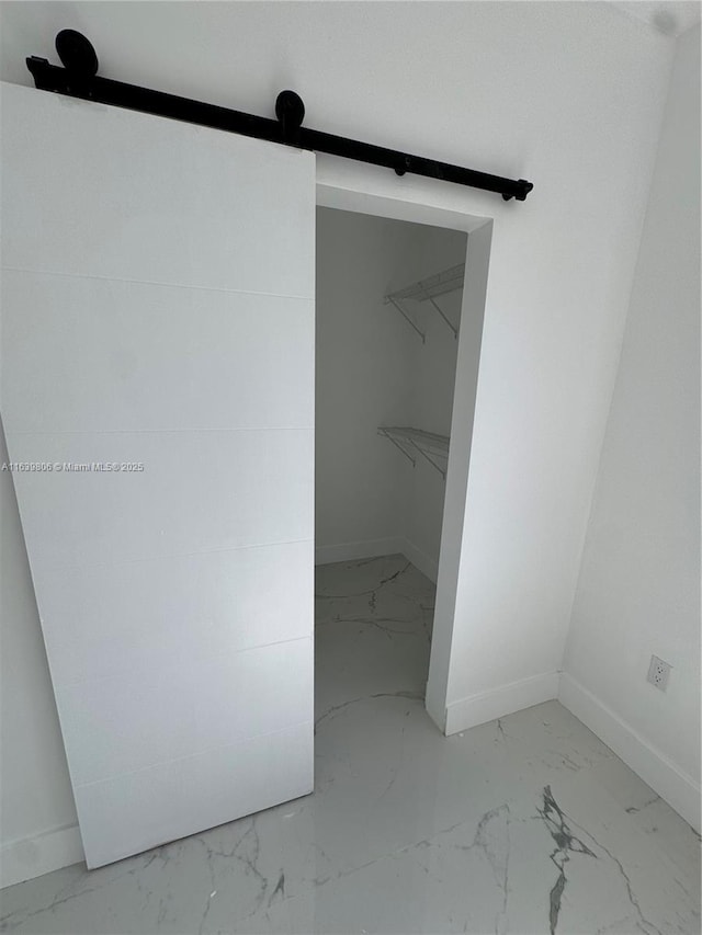 walk in closet with a barn door