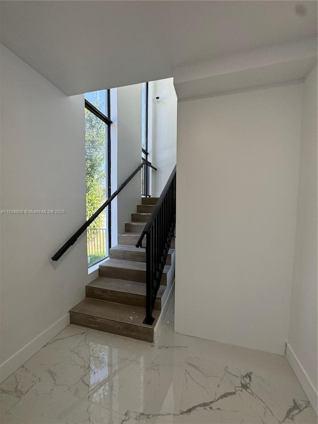 stairway with floor to ceiling windows