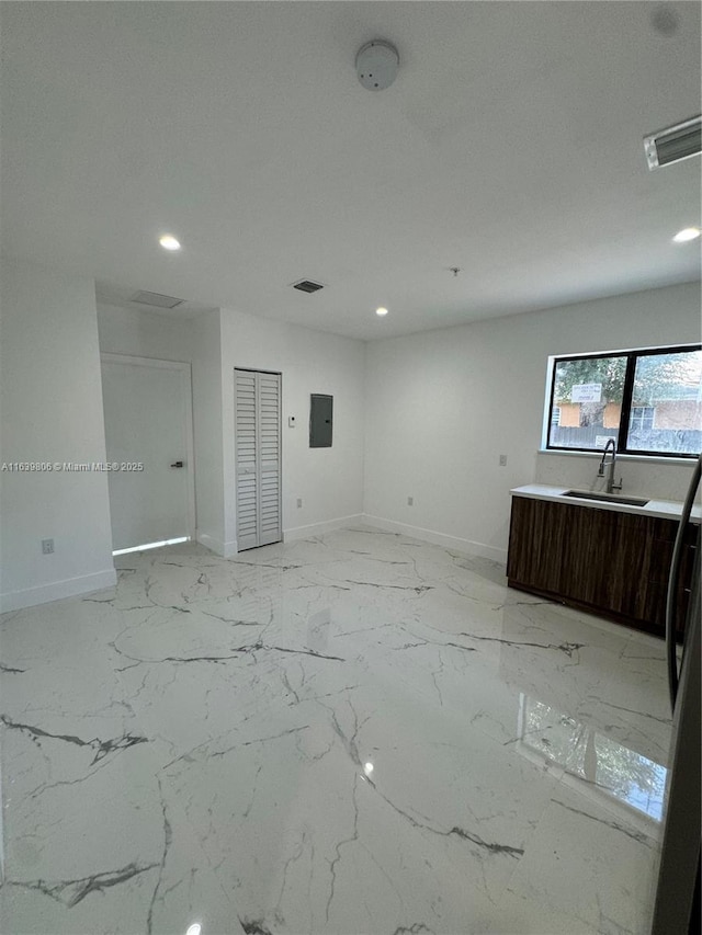 interior space with sink and electric panel