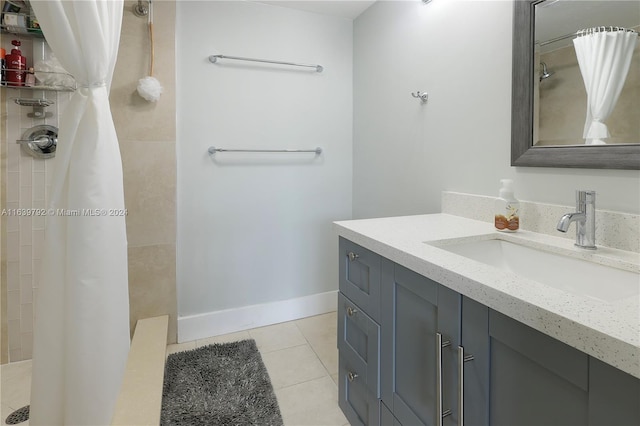 bathroom featuring vanity, walk in shower, and tile patterned flooring