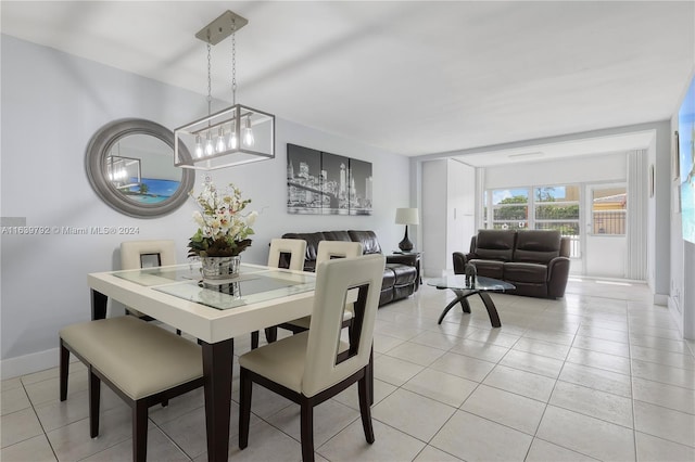 dining space with a notable chandelier and light tile patterned flooring