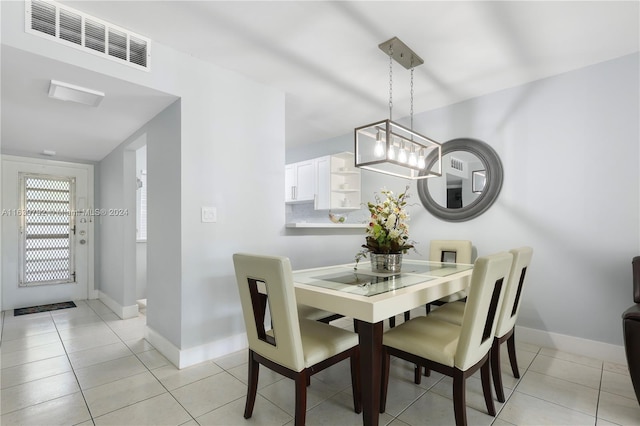 dining room featuring light tile patterned floors and a chandelier