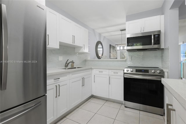 kitchen with appliances with stainless steel finishes, white cabinets, and sink