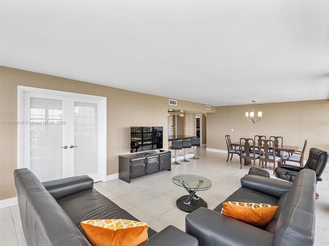 living room with light tile patterned floors and a notable chandelier