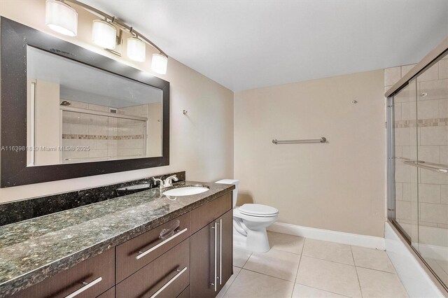 full bathroom featuring vanity, toilet, tile patterned flooring, and combined bath / shower with glass door