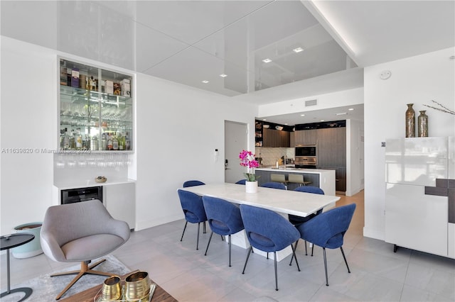 dining room featuring beverage cooler and light tile patterned floors