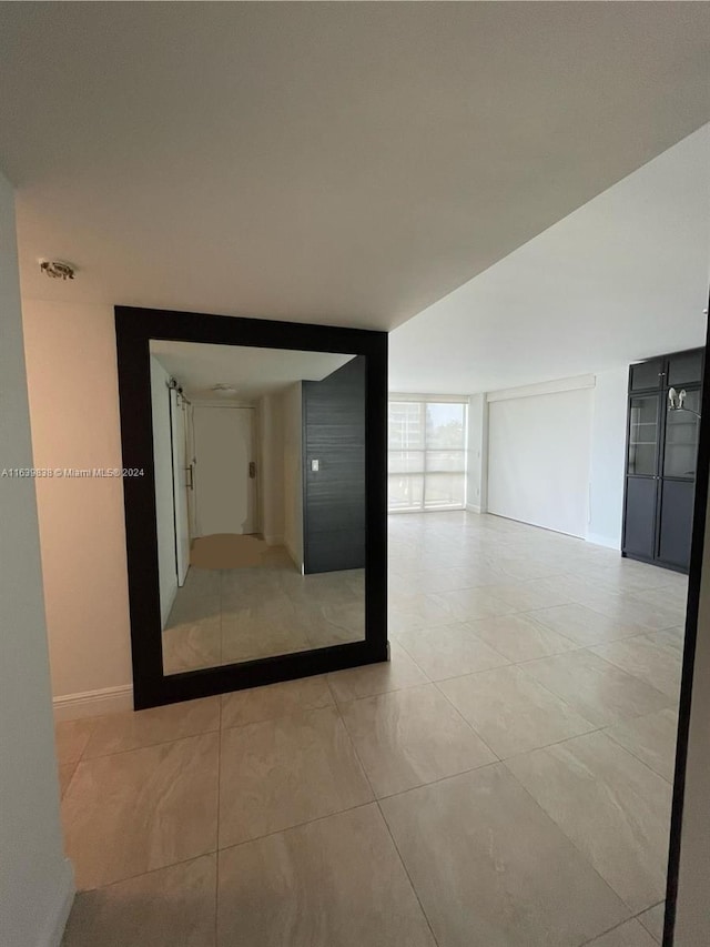 hallway with light tile patterned flooring