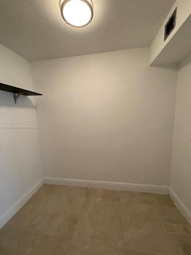 spacious closet featuring tile patterned flooring