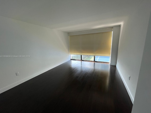 empty room with hardwood / wood-style flooring