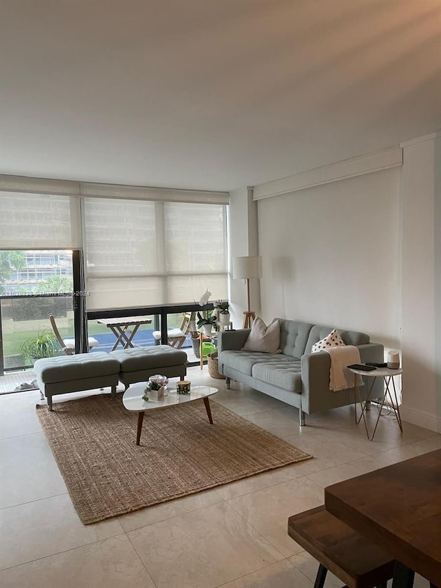 living room featuring light tile patterned floors and a wall of windows