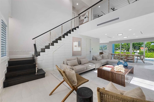 tiled living room featuring a towering ceiling