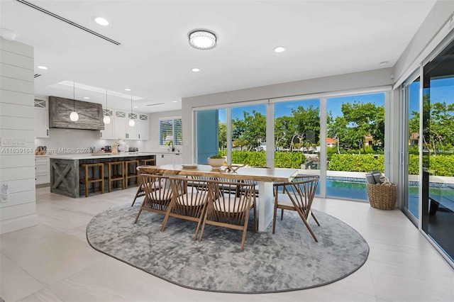 dining room featuring sink and light tile patterned floors