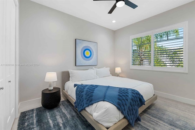 carpeted bedroom with ceiling fan and a closet