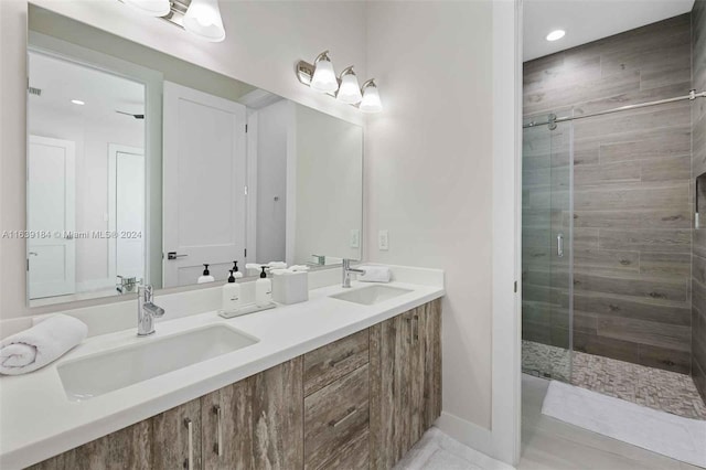 bathroom with dual vanity and walk in shower