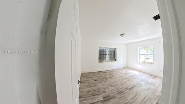 spare room with wood-type flooring