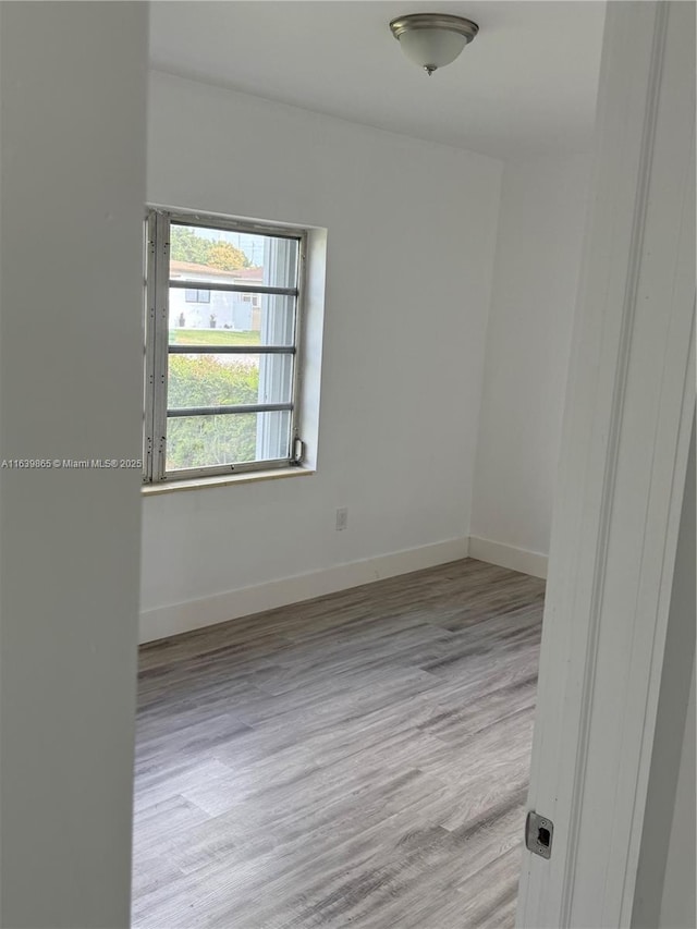 empty room with light hardwood / wood-style floors