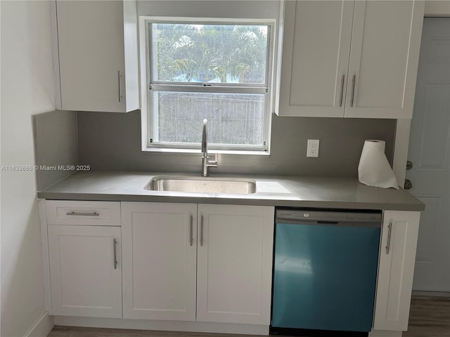 kitchen featuring dishwasher, white cabinetry, and sink