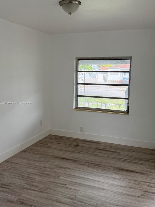 spare room with hardwood / wood-style floors