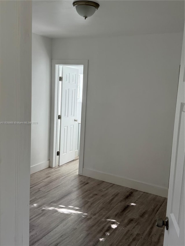 unfurnished room with hardwood / wood-style flooring