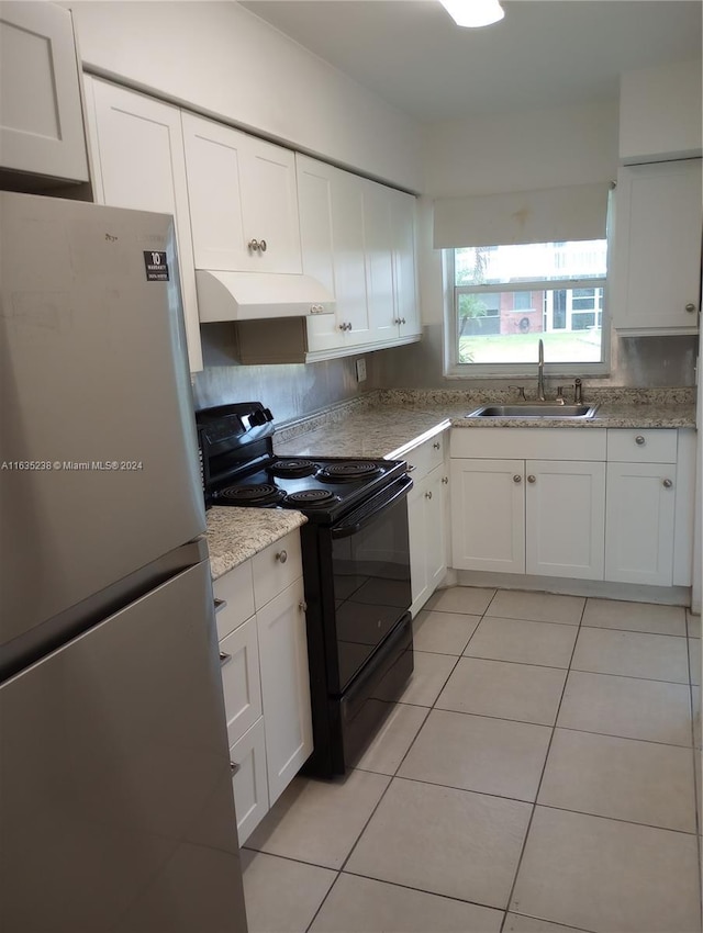 kitchen with sink, white cabinets, black electric range oven, fridge, and range hood