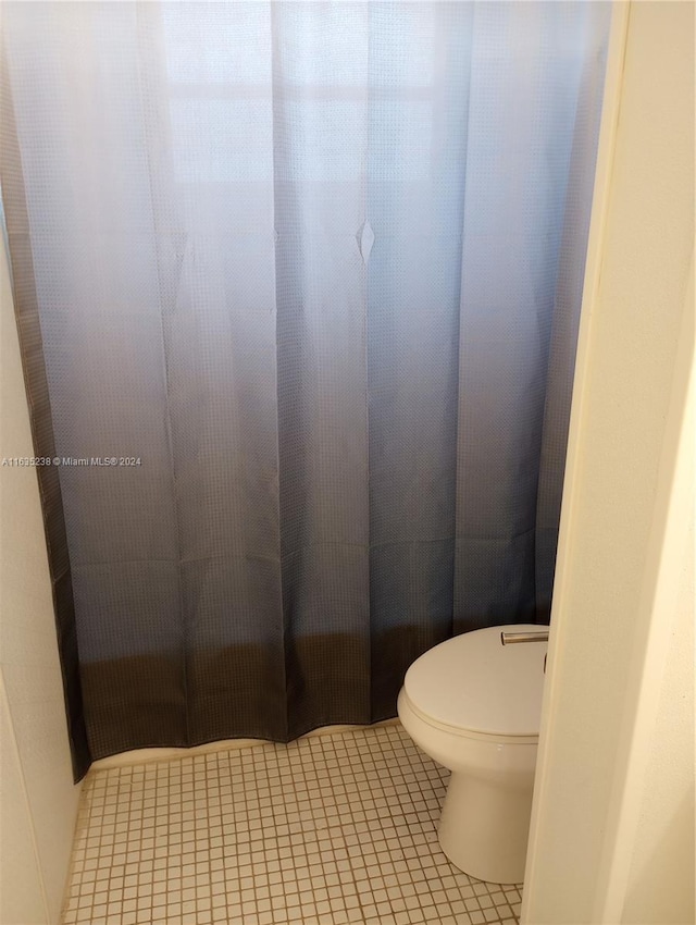 bathroom featuring toilet and tile patterned floors